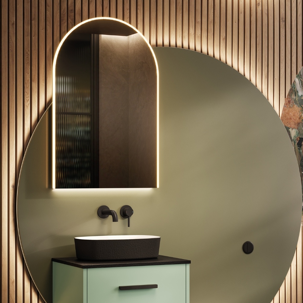 Lifestyle image of the hib. Alba Arch 500mm x 800mm LED Mirror mounted above a green vanity unity & black basin
